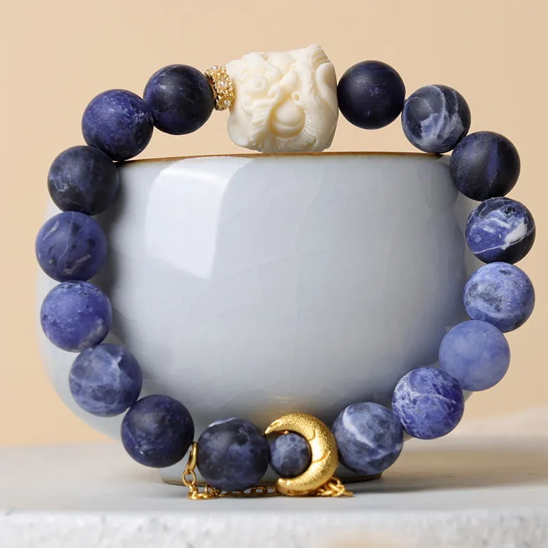 Luck Muse Sodalite Ivory Fruit Bracelet with Dancing Lion, Crescent Moon, and Harmony Design
